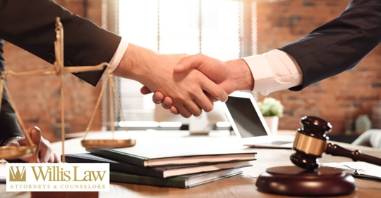 two businessman shaking hands in a law office